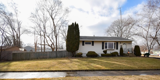 view of front facade with a front yard and fence