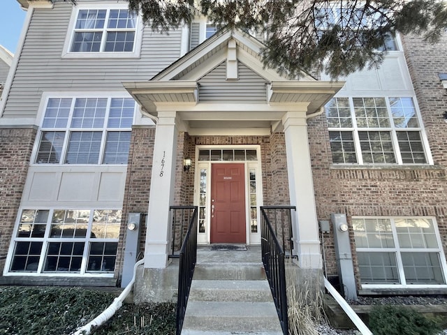 property entrance featuring brick siding