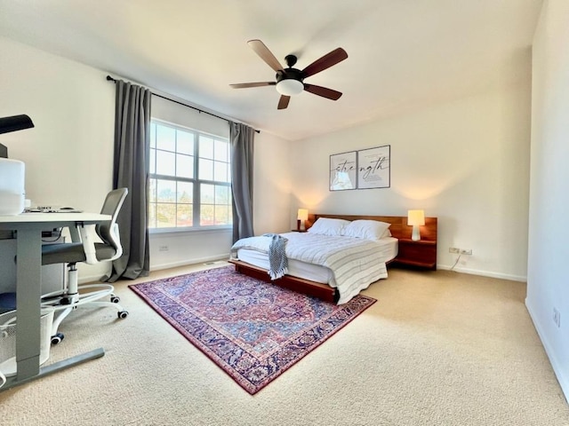 carpeted bedroom with ceiling fan and baseboards