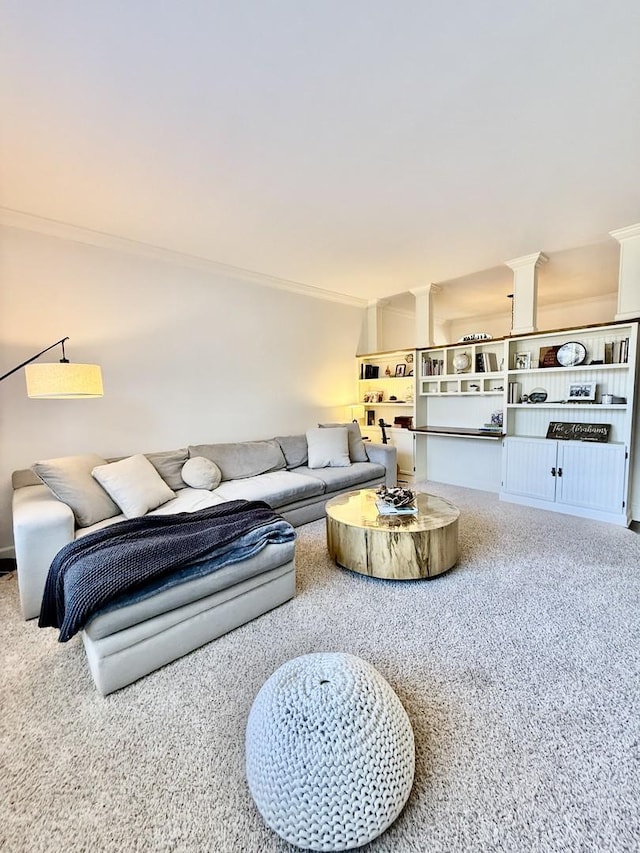 carpeted living room with decorative columns and crown molding