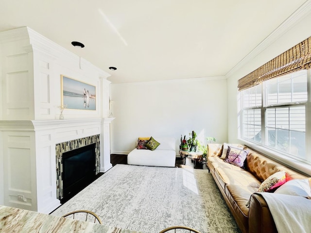 living area with ornamental molding and a fireplace