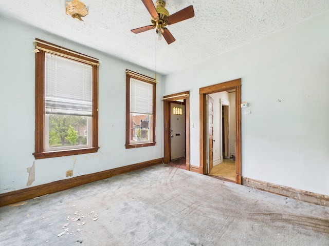 6725 S Justine St, Chicago, IL 60636 - carpeted empty room with a textured ceiling, baseboards, and ceiling fan