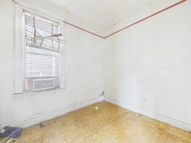 6725 S Justine St, Chicago, IL 60636 - unfurnished room featuring tile patterned floors, baseboards, and cooling unit