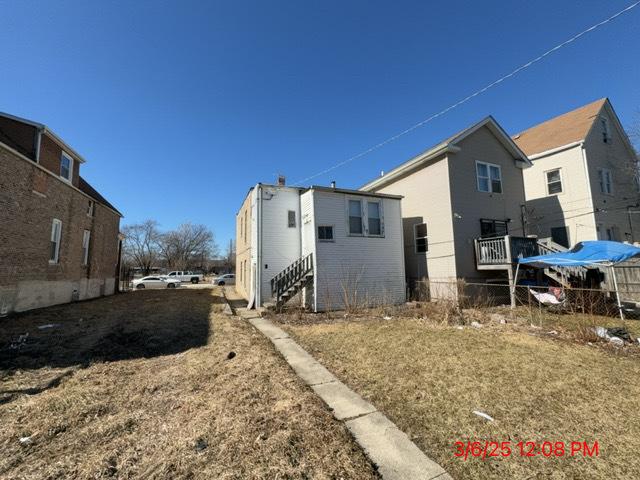 view of home's exterior featuring entry steps and fence