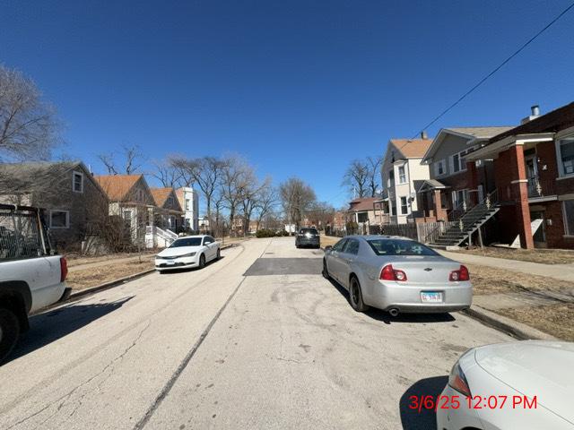 view of road featuring sidewalks, a residential view, and curbs