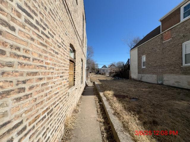 view of property exterior featuring brick siding