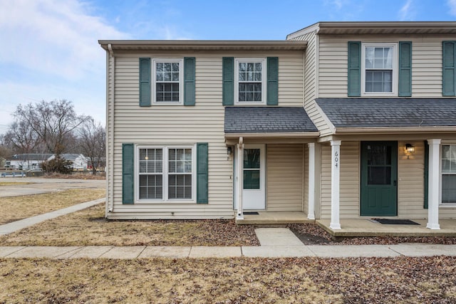 view of front of home with a porch and roof with shingles