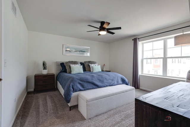 bedroom with a ceiling fan, baseboards, visible vents, and carpet floors