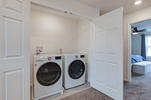 washroom with ceiling fan, washer and clothes dryer, light carpet, laundry area, and light tile patterned floors