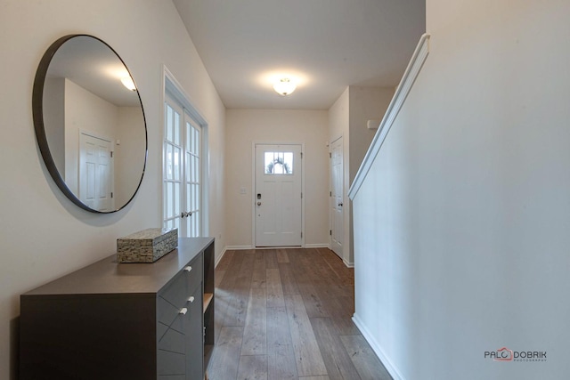 entrance foyer featuring stairway, baseboards, and hardwood / wood-style floors