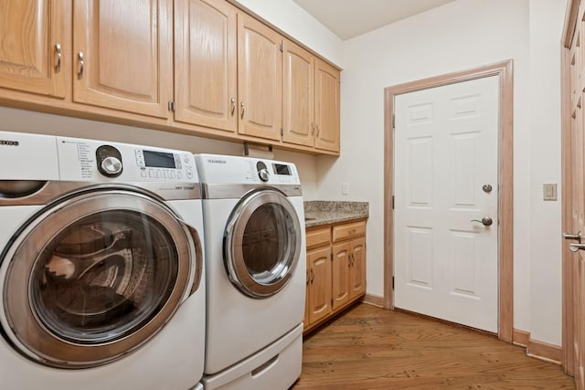 laundry room featuring light wood-style flooring, cabinet space, independent washer and dryer, and baseboards