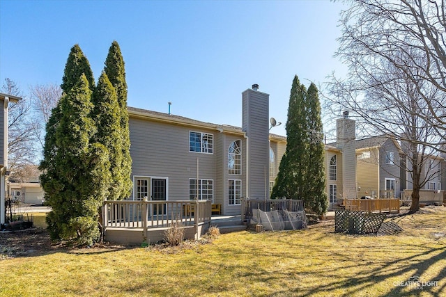 back of house with a deck, a chimney, and a yard