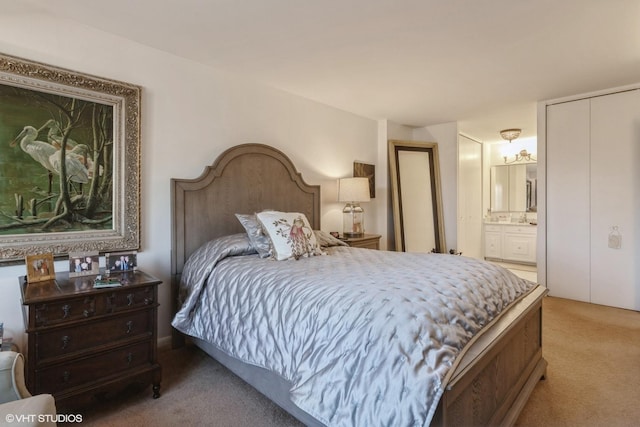 bedroom featuring light colored carpet and connected bathroom