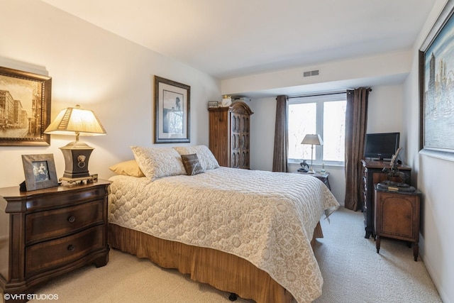 bedroom with light carpet and visible vents