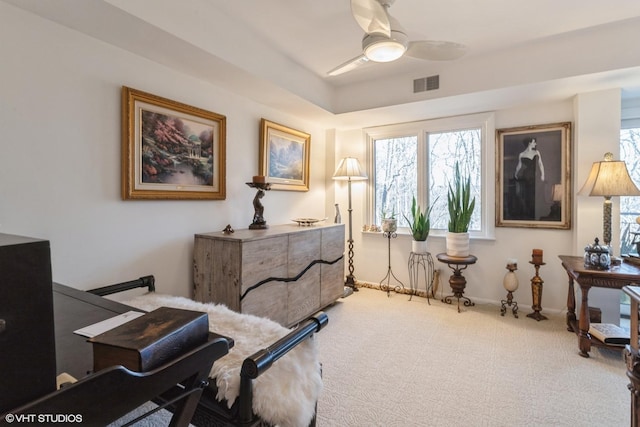 interior space featuring visible vents, carpet flooring, baseboards, and a ceiling fan