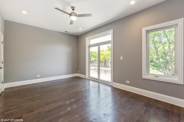 empty room featuring a ceiling fan, recessed lighting, dark wood-style flooring, and baseboards