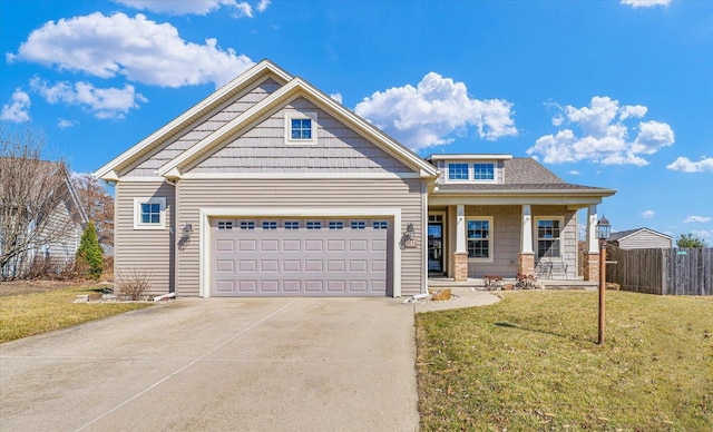 craftsman house featuring a front lawn, a porch, fence, concrete driveway, and an attached garage