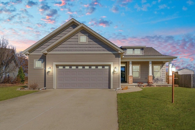 craftsman-style home with fence, driveway, a porch, an attached garage, and a front lawn