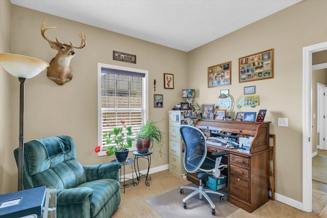 carpeted office space featuring baseboards