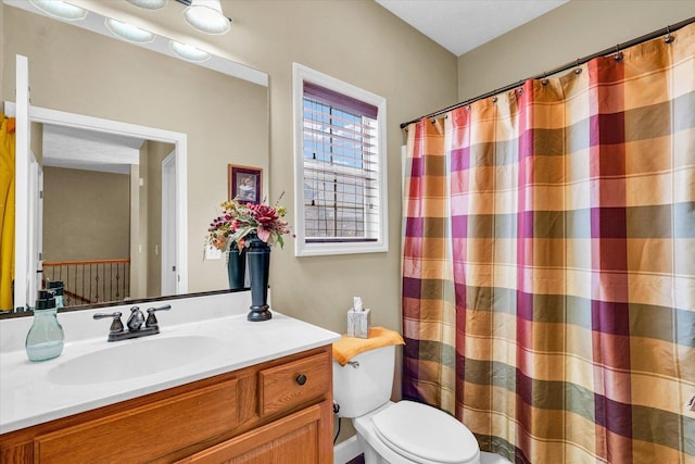 bathroom featuring vanity, a shower with shower curtain, and toilet