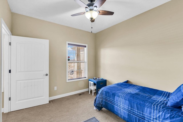 carpeted bedroom featuring visible vents, baseboards, and ceiling fan