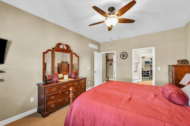 bedroom with visible vents, baseboards, light colored carpet, and ceiling fan