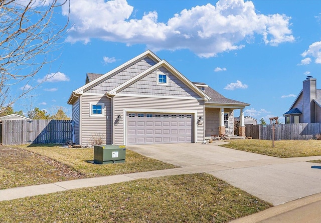 view of front of house featuring concrete driveway, a garage, fence, and a front yard