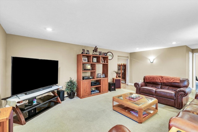 living area with recessed lighting, light colored carpet, and baseboards