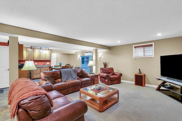 living area featuring light carpet, recessed lighting, baseboards, and a textured ceiling