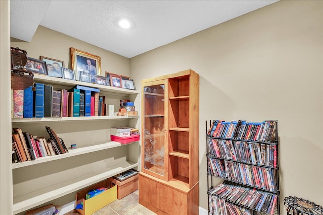 interior space featuring tile patterned flooring and a textured ceiling