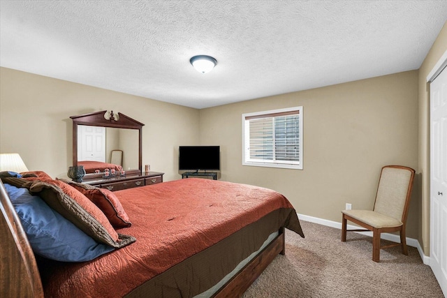 carpeted bedroom with a textured ceiling and baseboards