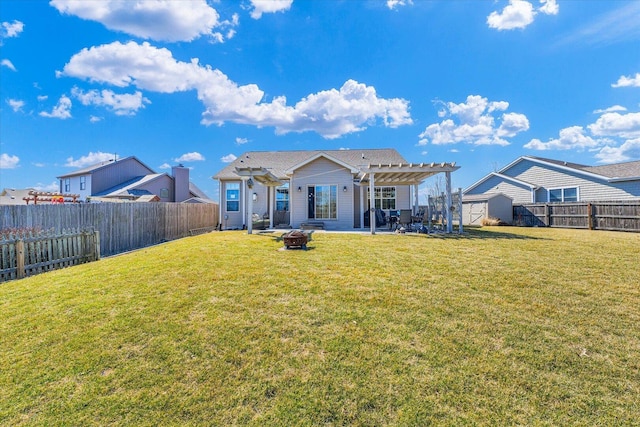 back of house with a fire pit, a lawn, a fenced backyard, a pergola, and a patio