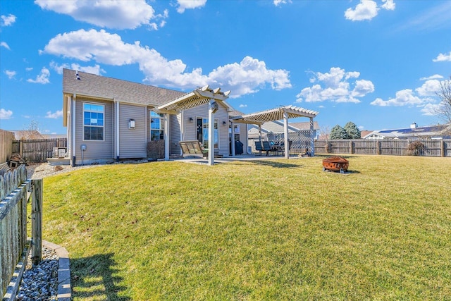 rear view of house with a fire pit, a yard, a fenced backyard, a pergola, and a patio