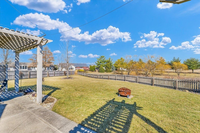 view of yard featuring a fire pit, a pergola, and a fenced backyard