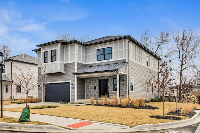 view of front of home featuring driveway, a shingled roof, and a garage