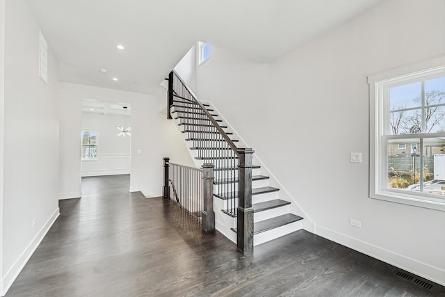 staircase with recessed lighting, visible vents, baseboards, and wood finished floors