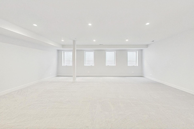 unfurnished room featuring light carpet, recessed lighting, and baseboards