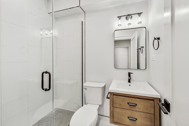 bathroom featuring vanity, toilet, and a stall shower