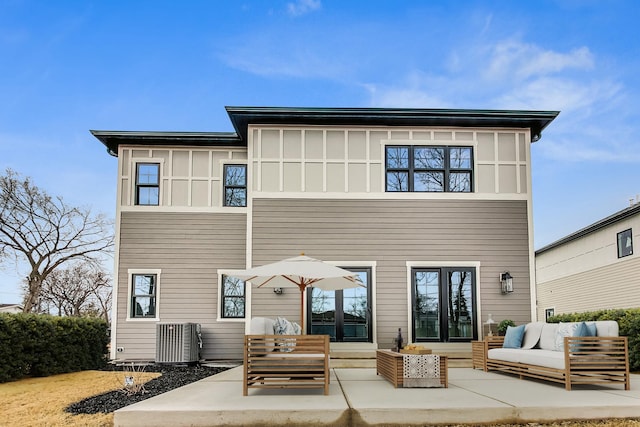 rear view of property featuring a patio area, central AC unit, board and batten siding, and outdoor lounge area