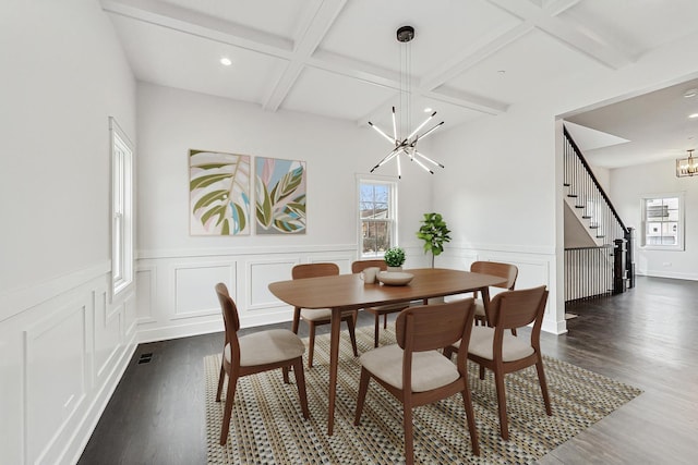 dining room with beamed ceiling, coffered ceiling, dark wood finished floors, stairway, and a chandelier