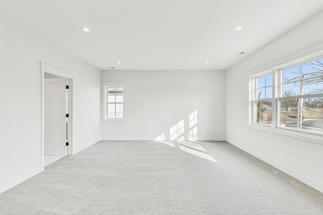 carpeted empty room featuring recessed lighting and baseboards