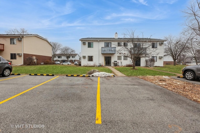 view of property featuring uncovered parking