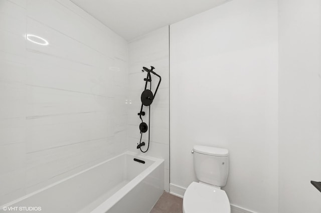 bathroom featuring toilet, shower / bath combination, and baseboards