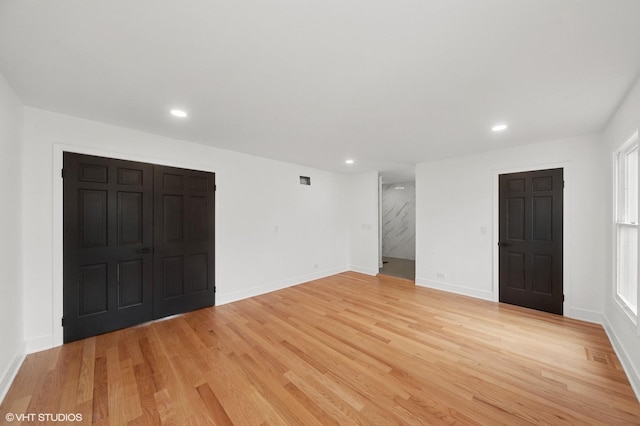 unfurnished bedroom with light wood-type flooring, baseboards, and recessed lighting