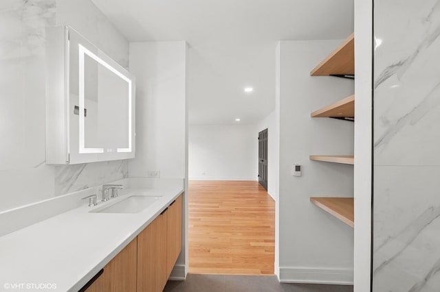 interior space featuring open shelves, light countertops, light wood-style flooring, a sink, and modern cabinets