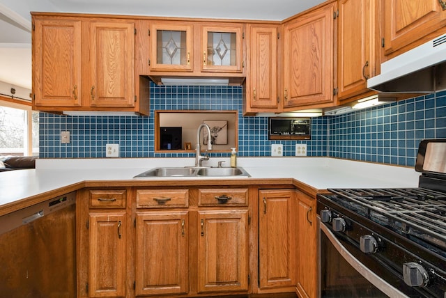 kitchen with dishwasher, light countertops, range with gas cooktop, and a sink