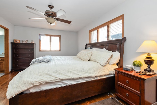 bedroom with a ceiling fan, multiple windows, and dark wood-style floors