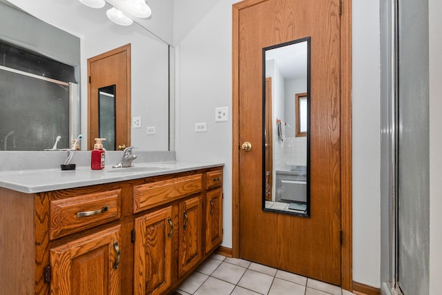 full bath with vanity, tile patterned floors, and a shower with shower door