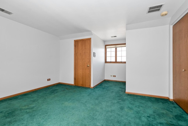 unfurnished room featuring carpet, visible vents, and baseboards