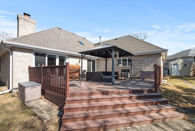 wooden deck with a gazebo, an outdoor living space, an outdoor structure, and a storage unit